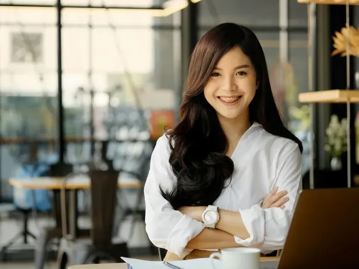 Smiling woman in a bright modern office, representing a confident local business owner using Local Biz Portal Now